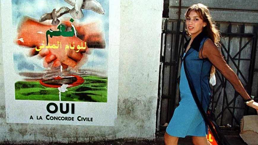 A young woman walks past posters for the referendum on "civil concord"
in Algiers, September 11, 1999. REUTERS/Zohra Bensemra

MDF197738.TIF - RTRR19H