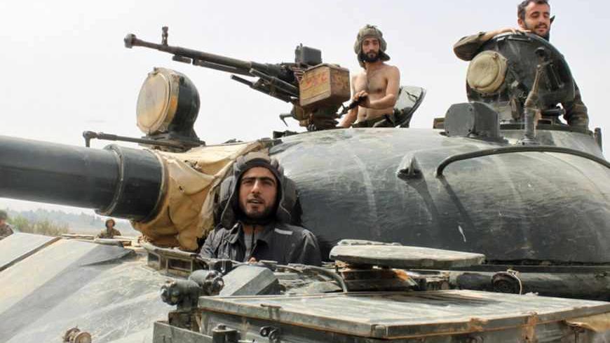 Forces of Syrian President Bashar al-Assad are seen in Arjoun village near Qusair town May 30, 2013. Syrian rebels under siege near the Lebanese border pleaded for help on Thursday against government troops and their Hezbollah allies as a confident Assad spoke of having new Russian missiles. REUTERS/ Rami Bleible (SYRIA - Tags: CONFLICT MILITARY) - RTX106EZ