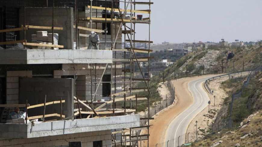 A labourer works on a construction site in a Jewish settlement near Jerusalem known to Israelis as Har Homa and to Palestinians as Jabal Abu Ghneim May 7, 2013. Prime Minister Benjamin Netanyahu has quietly curbed new building projects in Jewish settlements, an Israeli watchdog group and media reports said on Tuesday, in an apparent bid to help U.S. efforts to revive peace talks with the Palestinians. REUTERS/Ronen Zvulun (POLITICS BUSINESS CONSTRUCTION) - RTXZDI4