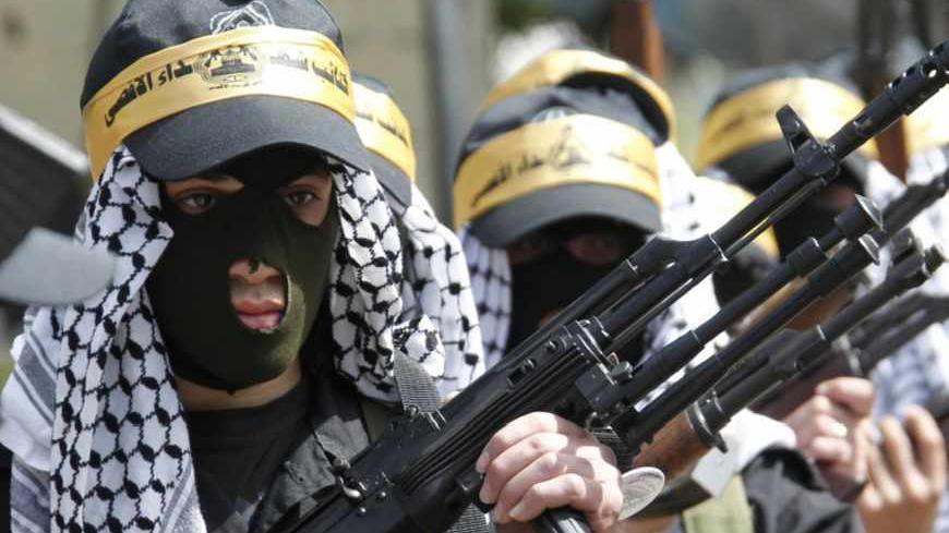 Palestinian Fatah members carry their weapons as they take part in a parade to mark the 65th anniversary of Nakba, at Ain al-Hilweh Palestinian refugee camp near the port-city of Sidon, southern Lebanon May 15, 2013. Palestinians marked "Nakba" (Catastrophe) to commemorate the expulsion or fleeing of hundreds of thousands of their brethren from their homes in the war that led to the founding of Israel in 1948. REUTERS/Ali Hashisho (LEBANON - Tags: POLITICS ANNIVERSARY) - RTXZN6R