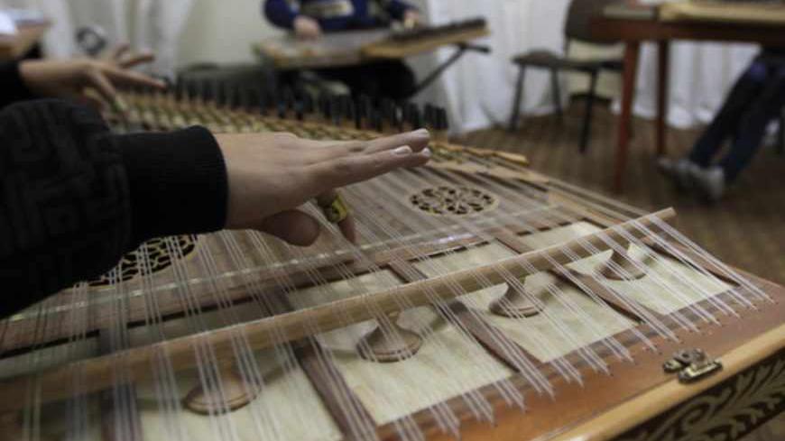 TO GO WITH STORY BY SARA HUSSEIN
Palestinian children play the qanun, a traditional Middle Eastern instrument, at the only music school in the Gaza Strip, at the headquarters of the Palestinian Red Crescent, on December 11, 2011. A room in Gaza's only music school fills with the sound of the qanun, a traditional Middle Eastern instrument, transporting listeners far from the impoverished territory.
AFP PHOTO/MAHMUD HAMS (Photo credit should read MAHMUD HAMS/AFP/Getty Images)