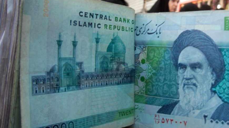 TO GO WITH AFP STORY BY SALAM FARAJ  
An Iraqi money dealer counts Iranian rial banknotes bearing a portrait of the late founder of the Islamic Republic of Iran, Ayatollah Ruhollah Khomeini, at an exchange office in Baghdad on February 3, 2012. Tens of thousands of Iranian visitors have been finding difficulty in using the Iranian currency in Iraq due to a depreciation of the rial against the dollar. AFP PHOTO/ ALI AL-SAADI (Photo credit should read ALI AL-SAADI/AFP/Getty Images)