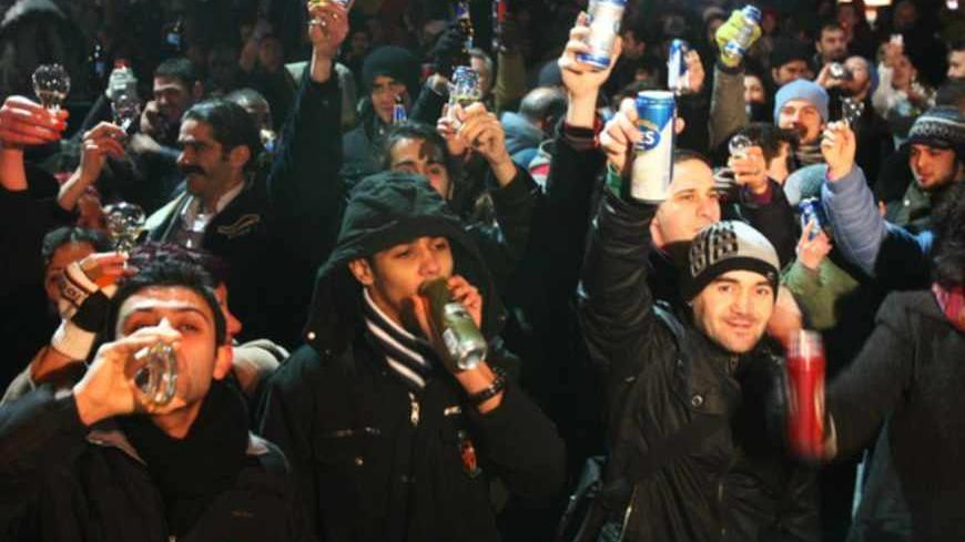 TO GO WITH AFP STORY BURAK AKINCI 
This photo taken on January 29, 2011, in Ankara, shows protesters drinking alcohol as they demonstrate against new laws banning alcohol sales in the Turkish capital and several Anatolian towns. Since 2002 the conservative ruling Justice and Development Party has brought many new bureaucratic hurdles to the sale of alcohol nationwide. Most recently, authorities in the province of Afyon tried to forbid alcohol completely but had to exlude "picnic" zones from the restriction 