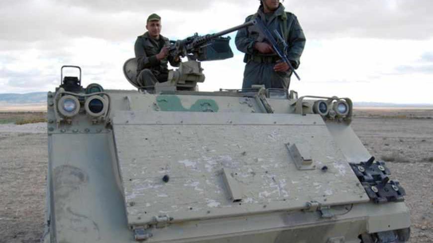 Tunisian soldiers stand on their tank as they take part in a search operation for gunmen in Dernaya Mountains in the Kasserine region, near the Algerian border, on December 11, 2012. Tunisian security forces have mounted a search operation for gunmen who carried out an attack in the Kasserine region, killing a policeman, a security source said. AFP PHOTO / ABDERRAZEK KHLIFI        (Photo credit should read ABDERRAZEK KHLIFI/AFP/Getty Images)