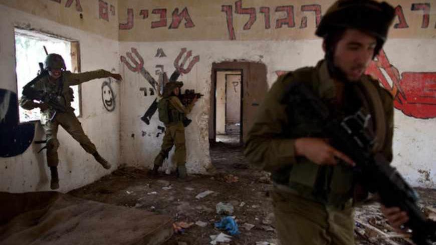GOLAN HEIGHTS - MAY 06: (ISRAEL OUT) A Israeli soldiers of the Golani brigade take part in an exercise near the border with Syria  on May 6, 2013  at the Israeli-annexed Golan Heights. Syria has accused Israel of launching a series of airstrikes on targets near the Lebanon/Syria border, including an arms shipment and the Jamraya research centre, that was thought to produce chemical weapons. (Photo by Uriel Sinai/Getty Images)