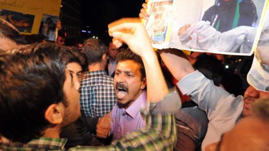 Syrian opposition activists argue outside the venue of the main opposition National Coalition meeting in Istanbul on May 26, 2013. Angry at the Coalition's failure to reach any agreement, a group of some 15 protesters gathered outside the hotel where the group was meeting, with some demanding speedier action and others rejecting negotiations outright."We want them to decide. They've been in there four days, discussing expansion while they should be taking a stand against Iran and Hezbollah's attack on Qusay