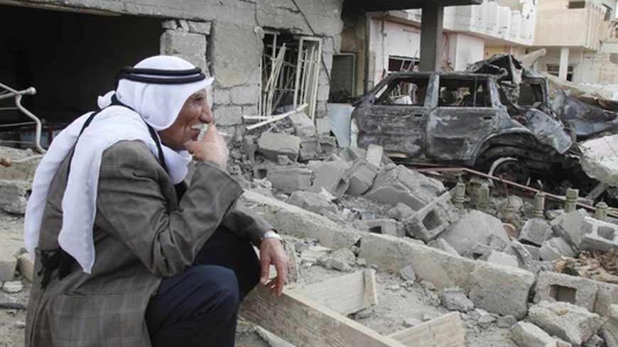 A man smokes a cigarette as he sits at the site of a bomb attack in Kirkuk, 250 km (155 miles) north of Baghdad, March 29, 2013. Car bombs hit four Shi'ite mosques in the Iraqi capital Baghdad and another in Kirkuk just after prayers on Friday, tearing into crowds of worshippers and killing 17, police and witnesses said. Sunni Islamists linked to al Qaeda's Iraqi wing have stepped up attacks this year and often target Shi'ite sites in a growing sectarian confrontation a decade after the U.S.-led invasion. R