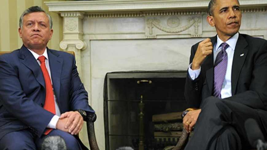 U.S. President Barack Obama (R) and Jordan's King Abdullah await questions from the press prior to a bilateral meeting in the Oval Office of the White House to discuss issues like the Syrian crisis and regional security, in Washington, April 26, 2013. REUTERS/Mike Theiler (UNITED STATES - Tags: POLITICS) - RTXZ1AA