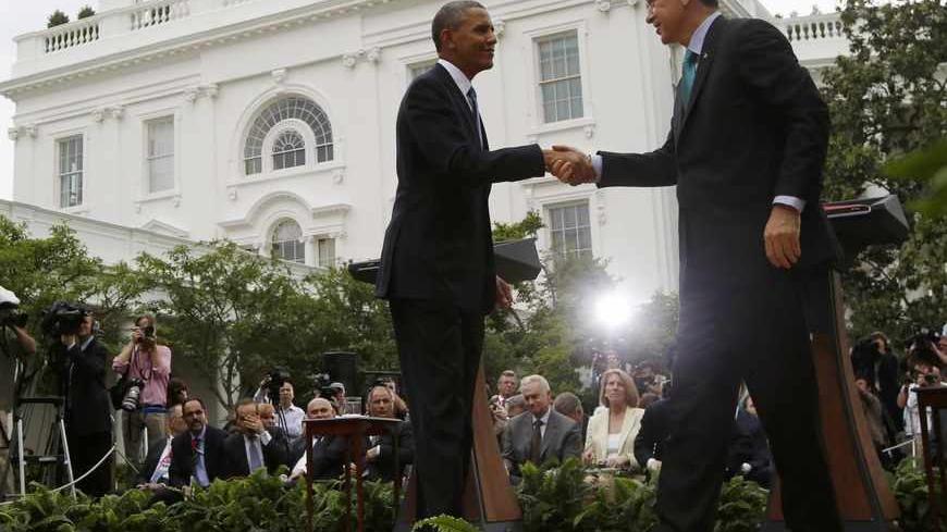 U.S. President Barack Obama and Turkey's Prime Minister Recep Tayyip Erdogan (R) shake hands at the end of their joint news conference in the Rose Garden of the White House in Washington, May 16, 2013. REUTERS/Jason Reed (UNITED STATES - Tags: POLITICS) - RTXZPEK