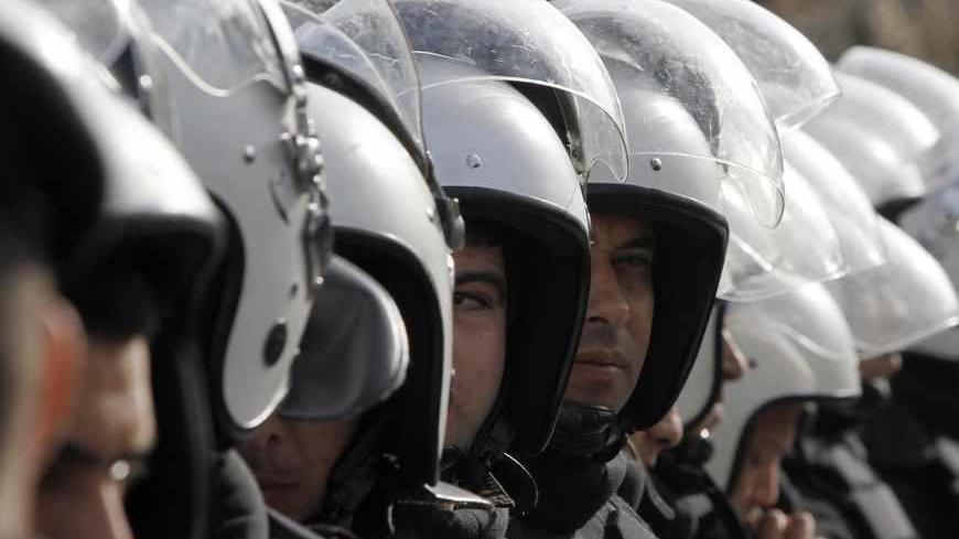 Members of the Palestinian security forces stand guard as a protest is held during the visit of U.S. Secretary of State Hillary Clinton in the West Bank city of Ramallah November 21, 2012.  Israeli air strikes shook the Gaza Strip and Palestinian rockets struck across the border as Clinton held talks in Jerusalem in the early hours of Wednesday, seeking a truce that can hold back Israel's ground troops. REUTERS/Mohamad Torokman (WEST BANK - Tags: POLITICS CIVIL UNREST MILITARY) - RTR3AONI
