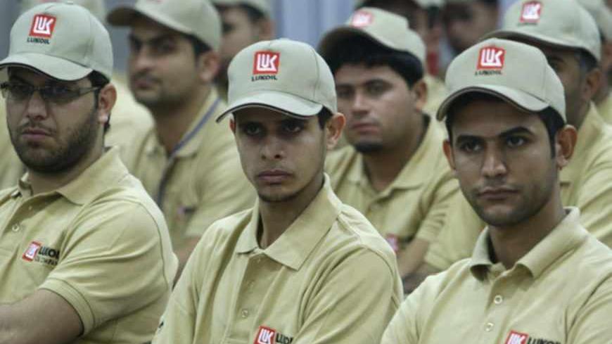 Workers attend a training class at LUKOIL training centre in the southern city of Basra December 25, 2012. Russian oil firm LUKOIL has opened its first training centre located in al-Rumaila in the southern city of Basra to develop skilled staff to work in its oilfield. The firm, Russia's second-largest crude producer, won a contract to develop the West Qurna-2 oilfield. Picture taken December 25, 2012.   REUTERS/Atef Hassan (IRAQ - Tags: ENERGY BUSINESS) - RTR3C2HM