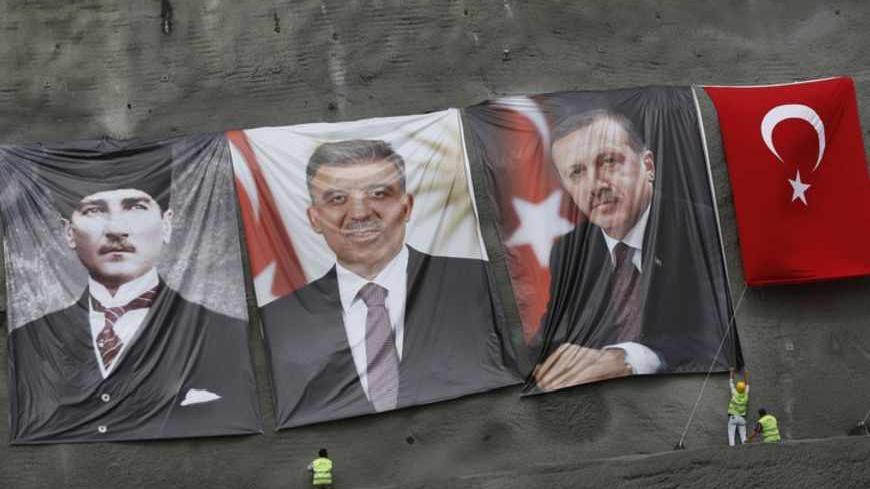 Workers hang portraits of modern Turkey's founder Mustafa Kemal Ataturk (L), President Abdullah Gul (2nd L) and Prime Minister Tayyip Erdogan before a groundbreaking ceremony for the third Bosphorus bridge linking the European and Asian sides of Istanbul May 29, 2013. REUTERS/Murad Sezer (TURKEY - Tags: BUSINESS CONSTRUCTION POLITICS) - RTX1051J