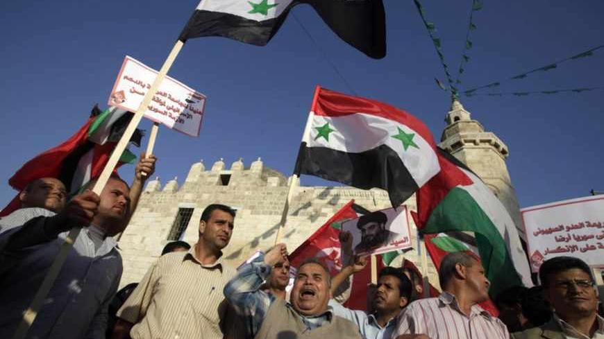 Palestinian supporters of leftist parties take part in a protest against Israeli air strikes close to Damascus, in Khan Younis in the southern Gaza Strip May 7, 2013. Israel played down weekend air strikes close to Damascus reported to have killed dozens of Syrian soldiers, saying they were not aimed at influencing its neighbour's civil war but only at stopping Iranian missiles reaching Lebanese Hezbollah militants. REUTERS/Ibraheem Abu Mustafa (GAZA - Tags: POLITICS CIVIL UNREST) - RTXZDWI