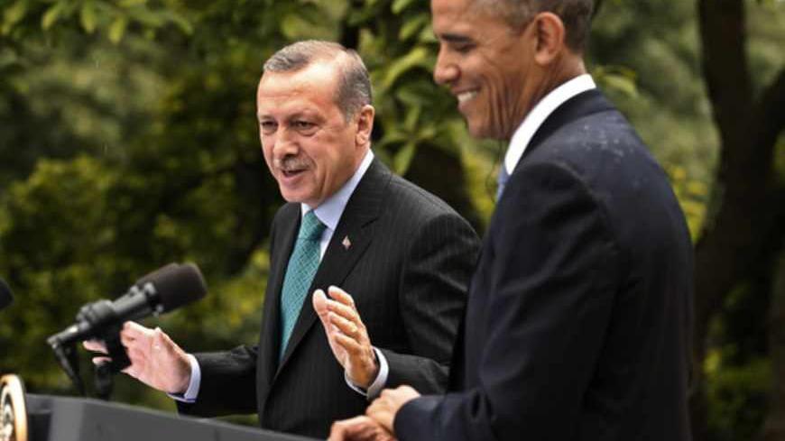 Turkish Prime Minister Recep Tayyip Erdogan (L) answers a question as U.S. President Barack Obama (R) listens during a joint news conference in the White House Rose Garden in Washington, May 16, 2013.    REUTERS/Kevin Lamarque (UNITED STATES  - Tags: POLITICS)   - RTXZPFQ