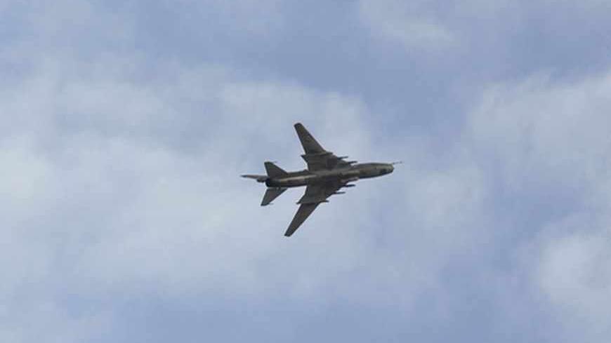 A Syrian Air Force fighter plane flies over the Syrian town of Ras al-Ain during an air strike, as seen from the Turkish border town of Ceylanpinar, Sanliurfa province November 13, 2012. A Syrian warplane struck homes in the town of Ras al-Ain on Tuesday within sight of the Turkish border, pursuing an aerial bombardment to force out rebels and drawing a new warning from Ankara. The second day of jet strikes sent Syrians scurrying through the flimsy barbed-wire fence that divides Ras al-Ain from the Turkish 