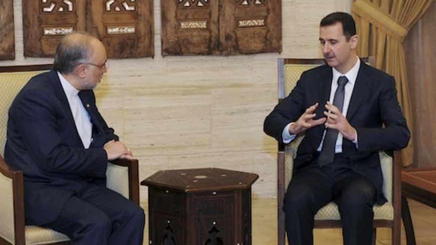 Syria's President Bashar al-Assad (R) meets Iran's Foreign Minister Ali Akbar Salehi in Damascus September 19, 2012, in this handout photograph released by Syria's national news agency SANA.REUTERS/SANA (SYRIA - Tags: POLITICS ) FOR EDITORIAL USE ONLY. NOT FOR SALE FOR MARKETING OR ADVERTISING CAMPAIGNS. THIS IMAGE HAS BEEN SUPPLIED BY A THIRD PARTY. IT IS DISTRIBUTED, EXACTLY AS RECEIVED BY REUTERS, AS A SERVICE TO CLIENTS - RTR385DC