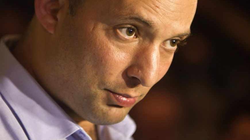 Naftali Bennett (L), head of the far-right Bayit Yehudi party, campaigns at a bar in Tel Aviv January 20, 2013. Israel will hold a parliamentary election on January 22. Bennett has emerged as the surprise success story of the country's election campaign, with polls predicting his party will win some 13 seats, and that a cabinet post for Bennett is likely. REUTERS/Nir Elias (ISRAEL - Tags: POLITICS ELECTIONS HEADSHOT) - RTR3CPCU