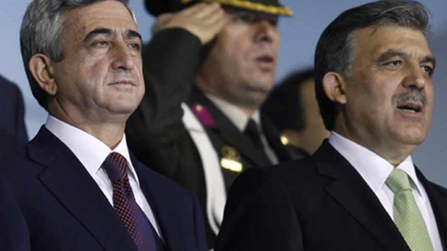 Presidents Serzh Sarksyan of Armenia (L)  and Abdullah Gul of Turkey listen to the national anthems prior the World Cup 2010 qualifying soccer match betwwen Turkey and Armenia at Ataturk stadium in Bursa, western Turkey, October 14, 2009. The presidents of Turkey and Armenia attended a World Cup soccer match courting popular support for an agreement to reopen their border and restore ties poisoned over a century of mutual hostility. REUTERS/Murad Sezer (TURKEY POLITICS SPORT SOCCER) - RTXPMWS