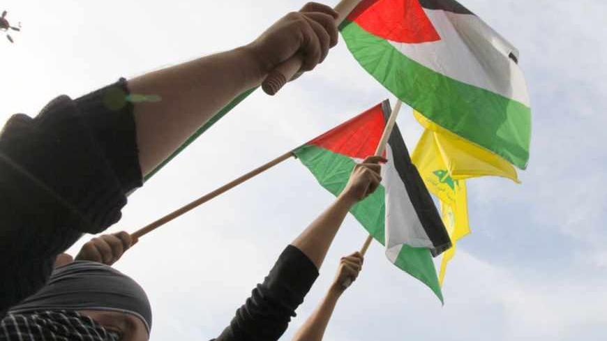Lebanon's Hezbollah supporters wave Palestinian and Hezbollah flags during a demonstration, organised by Lebanese and Palestinian factions, against Israel's military operation in Gaza, in front of the U.N. headquarters in Beirut November 17, 2012. Israeli aircraft bombed Hamas government buildings in Gaza on Saturday, including the prime minister's office, after Israel's cabinet authorised the mobilisation of up to 75,000 reservists, preparing for a possible ground invasion. REUTERS/Jamal Saidi (LEBANON - T