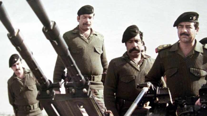 Saddam Hussein (R) stands with his guards behind him at an artillery
piece during the Iraq-Iran war in this undated file photo. The picture
is among exhibits at The Leader's Museum in Baghdad. British Prime
Minister Tony Blair published a dossier on Iraq's weapons programme on
Tuesday which claimed Saddam could launch weapons of mass destruction
at just 45 minutes' notice and was seeking to build a nuclear
capability. REUETRS/Handout

FK - RTRB072