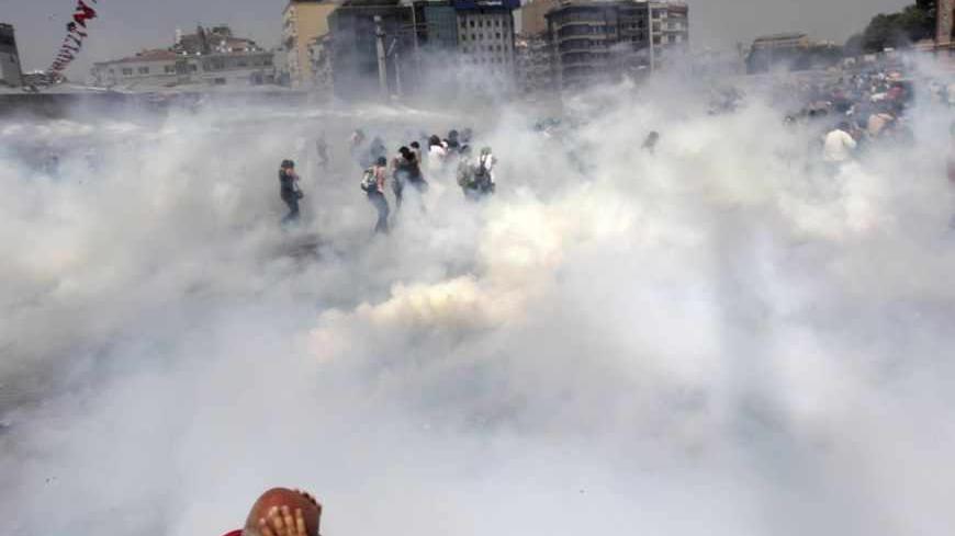 Riot police use tear gas to disperse the crowd during an anti-government protests at Taksim Square in central Istanbul May 31, 2013. Turkish police fired tear gas and water cannon on Friday at demonstrators in central Istanbul, wounding scores of people and prompting rallies in other cities in the fiercest anti-government protests for years. REUTERS/Osman Orsal (TURKEY - Tags: POLITICS CIVIL UNREST TPX IMAGES OF THE DAY) - RTX107MT
