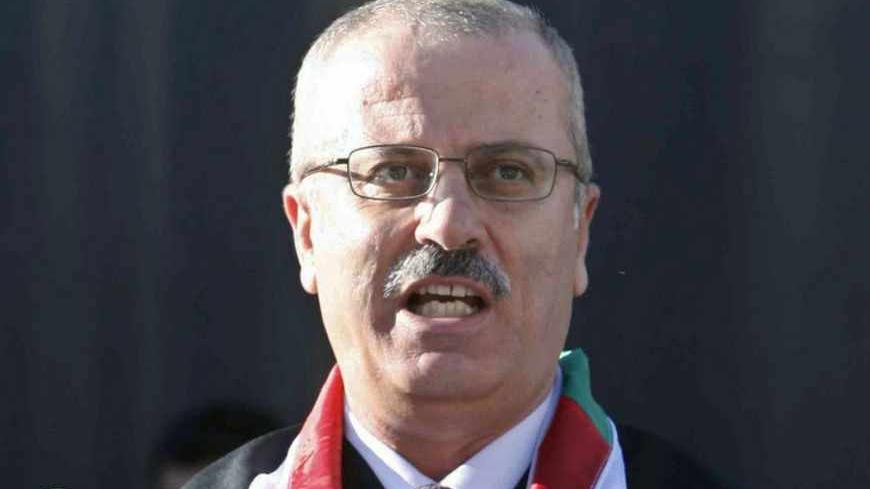 Rami Hamdallah, President of al-Najah National University, speaks during a graduation ceremony at the university in the West Bank city of Nablus June 16, 2011. Palestinian President Mahmoud Abbas named British-educated political independent Hamdallah as new prime minister on June 2, 2013, a move that was immediately condemned by Gaza Strip rulers Hamas. Picture taken June 16, 2011.  REUTERS/Abed Omar Qusini  (WEST BANK - Tags: POLITICS EDUCATION) - RTX109UZ