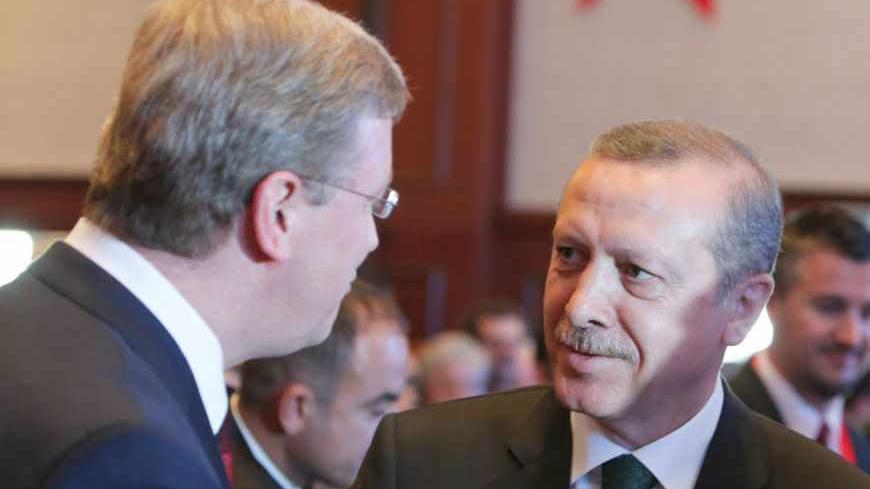Turkish Prime Minister Tayyip Erdogan (R) talks with European Union enlargement commissioner Stefan Fuele before the Istanbul Conference of the Ministry For EU Affairs in Istanbul June 7, 2013. Turkey must investigate whether police used excessive force in a crackdown on days of anti-government demonstrations and hold those responsible to account, Fuele said on Friday. REUTERS/Osman Orsal (TURKEY  - Tags: CIVIL UNREST POLITICS) - RTX10F7A