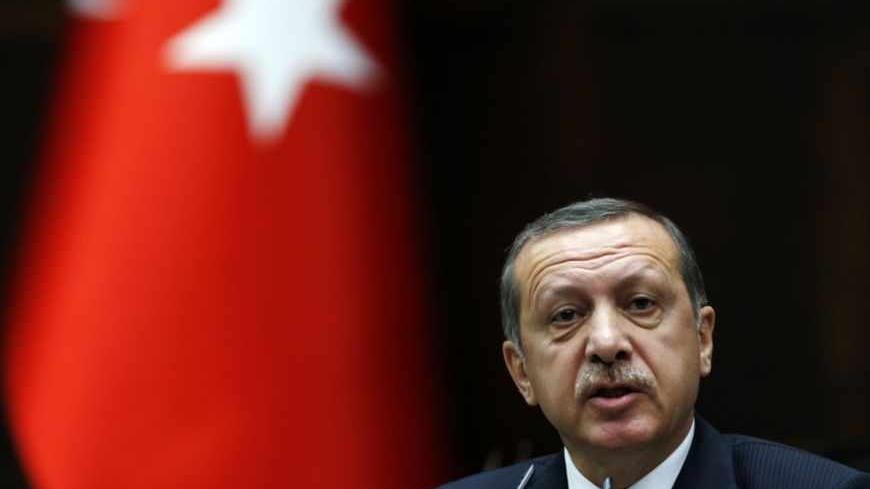 Turkey's Prime Minister Tayyip Erdogan addresses members of parliament from his ruling AK Party (AKP) during a meeting at the Turkish parliament in Ankara June 11, 2013. Erdogan called on protesters to withdraw from central Istanbul's Gezi Park on Tuesday and said the anti-government demonstrations were part of a deliberate attempt to damage Turkey's image and economy. REUTERS/Umit Bektas (TURKEY - Tags: POLITICS CIVIL UNREST) - RTX10JIE