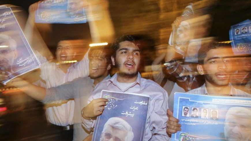 Supporters carry campaign posters for Iranian presidential candidate Saeed Jalili on the streets of Tehran June 12, 2013. Picture taken June 12, 2013.  REUTERS/ISNA/Mehdi Ghassemi  (IRAN - Tags: POLITICS ELECTIONS) ATTENTION EDITORS - THIS IMAGE WAS PROVIDED BY A THIRD PARTY. FOR EDITORIAL USE ONLY. NOT FOR SALE FOR MARKETING OR ADVERTISING CAMPAIGNS. THIS PICTURE IS DISTRIBUTED EXACTLY AS RECEIVED BY REUTERS, AS A SERVICE TO CLIENTS - RTX10M61