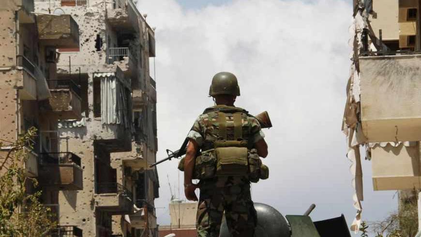 A Lebanese army soldier stands atop of an armoured personnel carrier (APC) as he patrols the area near the mosque complex where hardline Sunni cleric Sheikh Ahmed al-Assir was believed to be sheltering with his supporters, in Abra near Sidon, southern Lebanon June 25, 2013. The Lebanese government will try on Tuesday to secure the country after the deadliest violence since the start of a two-year conflict in neighbouring Syria that has pushed Lebanon's myriad militia to clashes. Gunfights between the army a