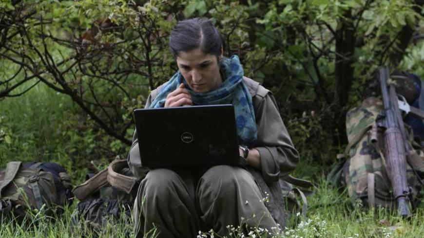 A member of Kurdistan Workers Party (PKK) works on her laptop in northern Iraq May 14, 2013. The first group of Kurdish militants to withdraw from Turkey under a peace process entered northern Iraq on Tuesday, and were greeted by comrades from the Kurdistan Workers Party (PKK), in a symbolic step towards ending a three-decades-old insurgency. The 13 men and women, carrying guns and with rucksacks on their backs, arrived in the area of Heror, near Metina mountain on the Turkish-Iraqi border, a Reuters witnes