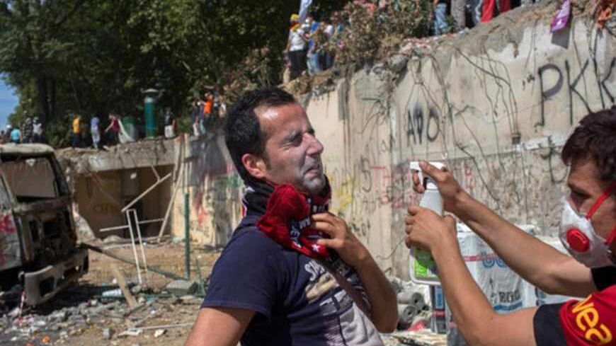 ISTANBUL, TURKEY - JUNE 11: Protesters aid one another after riot police used tear gas to disperse the crowd during a demonstration near Taksim Square on June 11, 2013 in Istanbul, Turkey. Istanbul has seen protests rage on for days, with two protesters and one police officer killed. What began as a protest over the fate of Taksim Gezi Park, has turned, with the heavy-handed response by police, into a protest over what is being seen as Prime Minister Recep Tayyip Erdogan's increasingly authoritarian agenda