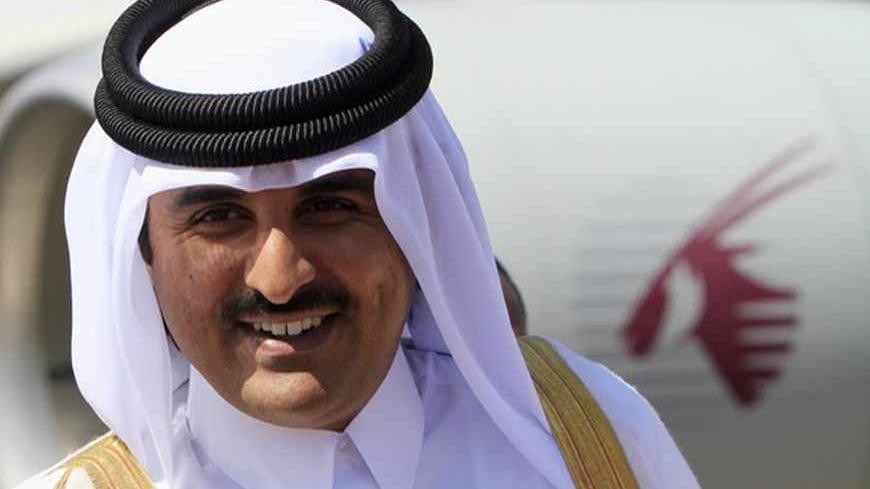 Qatar's Crown Prince Sheikh Tamim Bin Hamad Al Thani smiles during his arrival for an economic ties visit at Khartoum Airport December 4, 2011. REUTERS/Mohamed Nureldin Abdallah (SUDAN - Tags: POLITICS ROYALS BUSINESS) - RTR2UTVY