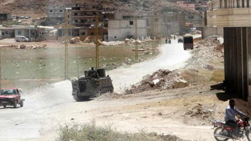 Lebanese Army soldiers patrol town of Arsal after being deployed to tighten security after two men died in clashes near a Lebanese army checkpoint June 6, 2013. Two men died in clashes near a Lebanese army checkpoint on Thursday, a security source said, in a possible spillover from the recent fighting in the nearby Syrian border town of Qusair.  REUTERS/Ahmad Shalha (LEBANON - Tags: CIVIL UNREST MILITARY POLITICS) - RTX10DYD
