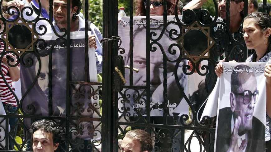 Intellectuals and artists, who are anti-Mursi protestors, carry pictures of some of the popular Egyptian artists and writers stand in front of the Ministry of Culture to demonstrate against what they claimed are increasing influence of the Muslim Brotherhood over the Ministry of Culture, in Cairo June 9, 2013. Egyptian President Mohamed Mursi increased the influence of his Muslim Brotherhood over government in a cabinet reshuffle in May that replaced two ministers involved in crucial talks with the IMF over