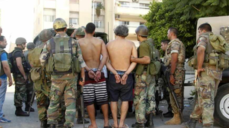 Lebanese army soldiers arrest supporters of hardline Sunni cleric Sheikh Ahmed al-Assir in Abra near Sidon, southern Lebanon, June 24, 2013. Lebanese soldiers stormed a complex holding gunmen loyal to a radical Islamist cleric in the city of Sidon on Monday and arrested dozens of his supporters, security sources said, in a second day of clashes fuelled by neighbouring Syria's civil war. REUTERS/Ali Hashisho (LEBANON - Tags: POLITICS CIVIL UNREST) - RTX10ZBT