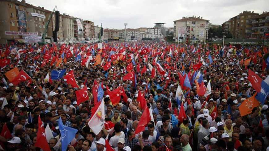 People wave flags during Turkey's Prime Minister Tayyip Erdogan speech at his rally in Ankara June 15, 2013. Erdogan warned protesters occupying a central Istanbul park that they should leave before a ruling party rally on Sunday or face eviction by the security forces. REUTERS/Dado Ruvic (TURKEY - Tags: POLITICS CIVIL UNREST) - RTX10OSI