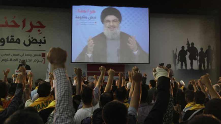 Lebanon's Hezbollah leader Sayyed Hassan Nasrallah  addresses his supporters from a screen during a rally to commemorate Hezbollah Wounded Veterans Day in Beirut suburbs June 14, 2013. REUTERS/Sharif Karim (LEBANON - Tags: POLITICS) - RTX10NPY