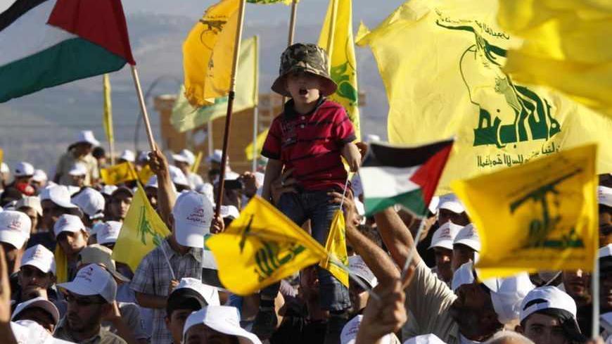 Supporters of Lebanon's Hezbollah wave Hezbollah and Palestinian flags during a rally to mark "Quds (Jerusalem) Day" in the southern Lebanese village of Maroun el-Ras, near the border with Israel, August 26, 2011. Lebanon's Hezbollah chief Sayyed Hassan Nasrallah, whose group is backed by Damascus, warned that the unrest in Syria will have implications on the whole region if it is not solved through dialogue. "We all support the need for big and important reforms, so Syria can be stronger...this means that