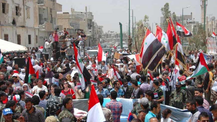 Lebanese and Syrian supporters of Syria's President Bashar al-Assad celebrate in Qusair June 9, 2013, after the Syrian army and Lebanese Hezbollah fighters took control of the town from rebel fighters in this handout photograph released by Syria's national news agency SANA. REUTERS/SANA/Handout via Reuters (SYRIA - Tags: POLITICS CIVIL UNREST) ATTENTION EDITORS - THIS IMAGE WAS PROVIDED BY A THIRD PARTY. FOR EDITORIAL USE ONLY. NOT FOR SALE FOR MARKETING OR ADVERTISING CAMPAIGNS. THIS PICTURE IS DISTRIBUTED