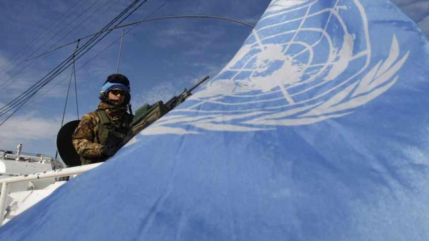 A U.N peacekeeper of the United Nations Interim Force in Lebanon (UNIFIL) on an armoured vehicle secures the area near the site of an explosion in the southern Lebanese town of Tair Harfa December 17, 2012. The big explosion rocked the southern Lebanese town of Tair Harfa on Monday, five km (three miles) from the border with Israel but there were no casualties, residents said. REUTERS/Ali Hashisho   (LEBANON - Tags: POLITICS CIVIL UNREST) - RTR3BO9R