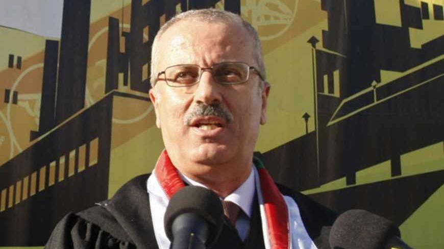 Rami Hamdallah, President of al-Najah National University, speaks during a graduation ceremony at the university in the West Bank city of Nablus June 16, 2011. Palestinian President Mahmoud Abbas named British-educated political independent Hamdallah as new prime minister on June 2, 2013, a move that was immediately condemned by Gaza Strip rulers Hamas. Picture taken June 16, 2011. REUTERS/Abed Omar Qusini (WEST BANK - Tags: POLITICS EDUCATION) - RTX109UY