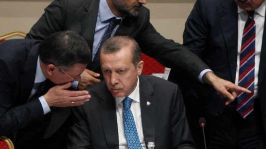 Turkey's Prime Minister Tayyip Erdogan (C) speaks with AK Party (AKP) members after an AKP meeting in Ankara June 14, 2013. Erdogan on Friday called on hundreds of protesters occupying central Istanbul's Gezi Park to leave, saying their message had been received by the government after talks aimed at ending two weeks of unrest. REUTERS/Dado Ruvic (TURKEY - Tags: POLITICS CIVIL UNREST) - RTX10NQ0