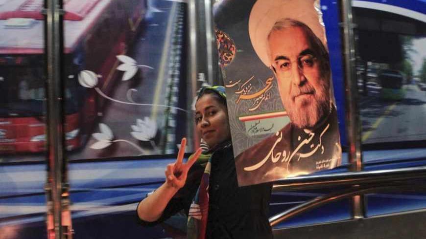 A supporter of moderate cleric Hassan Rohani celebrates his victory in Iran's presidential election along a street in Tehran June 16, 2013. Rohani won Iran's presidential election on Saturday, the interior ministry said, scoring a surprising landslide victory over conservative hardliners without the need for a second round run-off. REUTERS/Yalda Moayeri (IRAN - Tags: POLITICS ELECTIONS) - RTX10PBJ