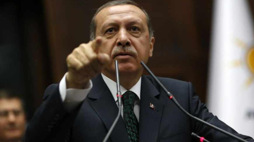 Turkey's Prime Minister Tayyip Erdogan addresses members of parliament from his ruling AK Party (AKP) during a meeting at the Turkish parliament in Ankara June 25, 2013. Turkish anti-terrorism police detained 20 people in raids in the capital Ankara on Tuesday in connection with weeks of anti-government protests across the country, media reports said. The unrest began at the end of May when police used force against campaigners opposed to plans to redevelop a central Istanbul park. The protest spiralled int