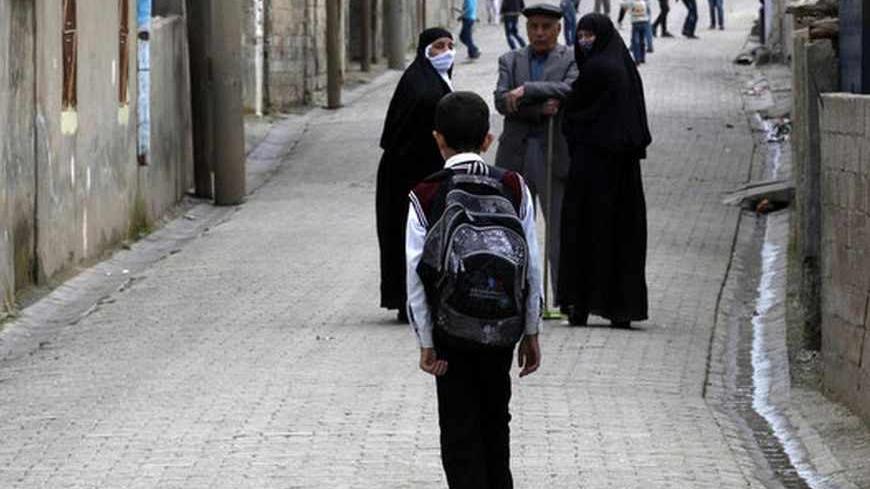 Ferhat Savun aged 11, walks to school through the town of Cizre in Sirnak province, near the border with Syria March 24, 2013. Picture taken March 24, 2013. Turkey's fledgling peace process with the Kurdistan Workers Party (PKK) militant group is all over the headlines. After three decades of war, 40,000 deaths and a devastating impact on the local economy, everybody seems ready for peace. Pro-Kurdish politicians are focused on boosting minority rights and stronger local government for the Kurds, who make u