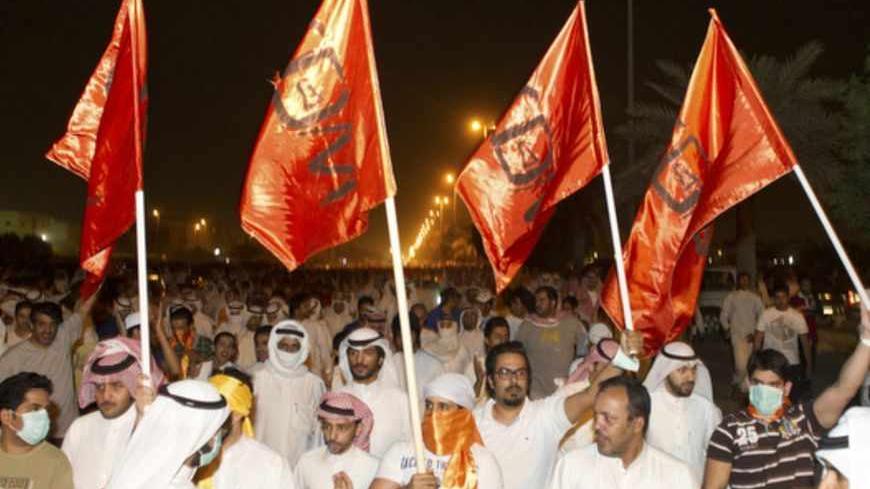 Supporters of Kuwaiti former member of parliament and opposition politician Musallam al-Barrak wave flags as they march towards the central prison in Andulos, after a ruling sentenced Barrak to jail for insulting the emir, April 15, 2013. Barrak was sentenced to five years in jail on Monday for insulting the emir, his lawyer said, in a ruling that brought thousands of people to the streets in protest. The Kuwaiti criminal court found Barrak guilty of insulting Sheikh Sabah al-Ahmad al-Sabah in a speech in O