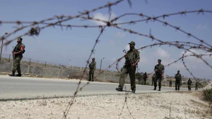 Members of the Hamas security forces patrol the border area between Gaza and Egypt, in the southern Gaza Strip May 20, 2013. Egyptian police angered by the kidnapping of seven colleagues by Islamist gunmen kept a crossing into the Gaza Strip closed again for four days, stranding hundreds of Palestinian travellers, witnesses said. REUTERS/Ibraheem Abu Mustafa (GAZA - Tags: POLITICS) - RTXZTTN