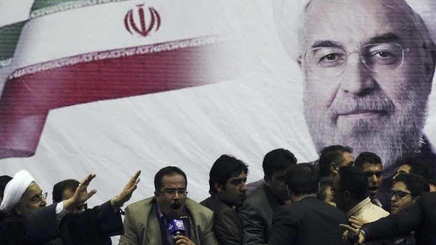 Iranian presidential candidate Hassan Rohani (L) waves to supporters in the central Iranian city of Shiraz June 11, 2013. Picture taken June 11, 2013. REUTERS/Fars News/Mohammad Hadi Khosravi (IRAN - Tags: POLITICS ELECTIONS) ATTENTION EDITORS - THIS IMAGE WAS PROVIDED BY A THIRD PARTY. FOR EDITORIAL USE ONLY. NOT FOR SALE FOR MARKETING OR ADVERTISING CAMPAIGNS. THIS PICTURE WAS PROCESSED BY REUTERS TO ENHANCE QUALITY. AN UNPROCESSED VERSION WILL BE PROVIDED SEPARATELY - RTX10L2E