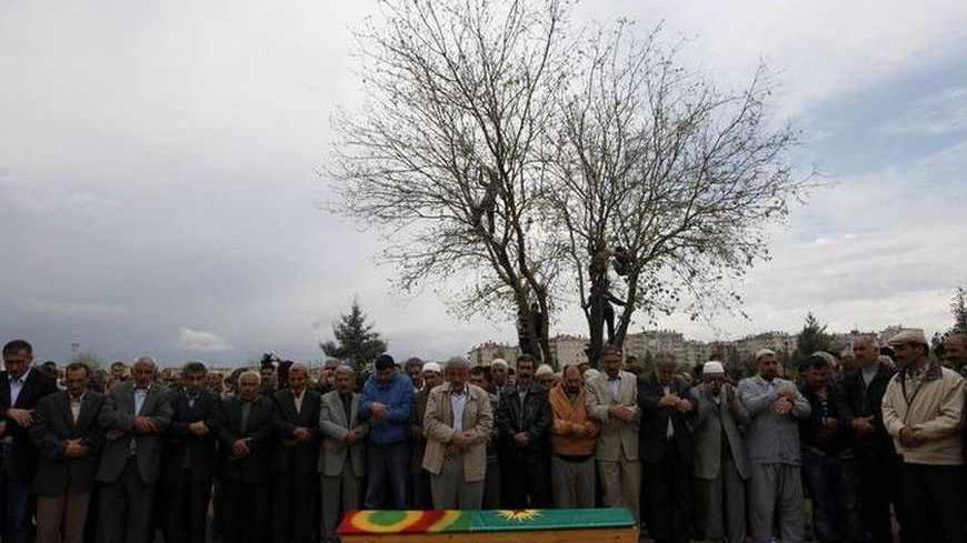 Relatives and friends of Savas Yayik pray behind his coffin during a funeral ceremony in Diyarbakir in the Kurdish-dominated southeastern Turkey April 26, 2011. Turkish security forces killed three Kurdish guerrillas, including Yayik, in a firefight in southeast Turkey, according to media reports last week, after two days of street clashes across the region. There was no indication of any link between those protests and the clash between soldiers and militants from the outlawed Kurdistan Workers Party (PKK)